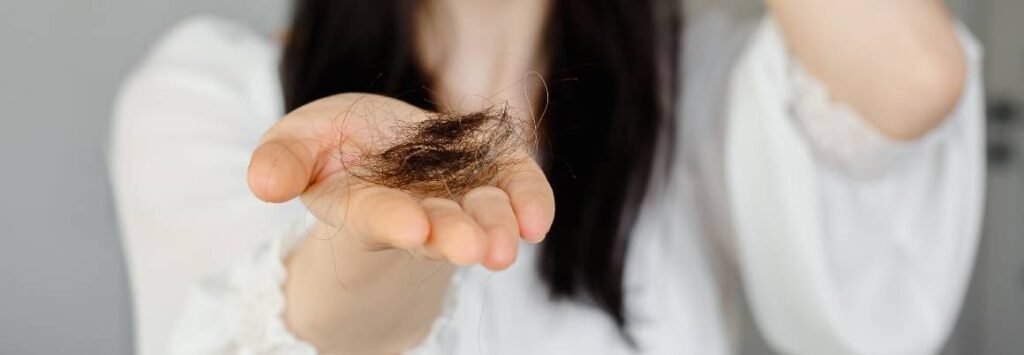 Zinc deficiency symptoms Woman Holding Loss Hair